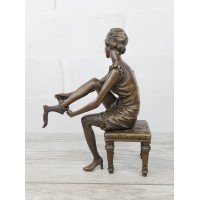 Statuette "A girl puts on a stocking"